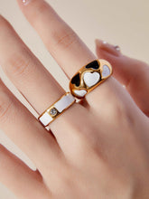 wearing black and white enamel rings